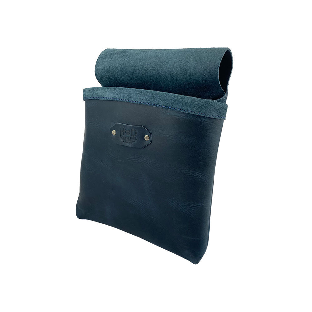 Side view of the Constructor Belt Bag in slate blue by Hide & Drink, an essential tool bag for constructors. This durable tool belt features a single large pocket made from high-quality full grain leather, handcrafted in La Antigua Guatemala & Oaxaca Mexico.