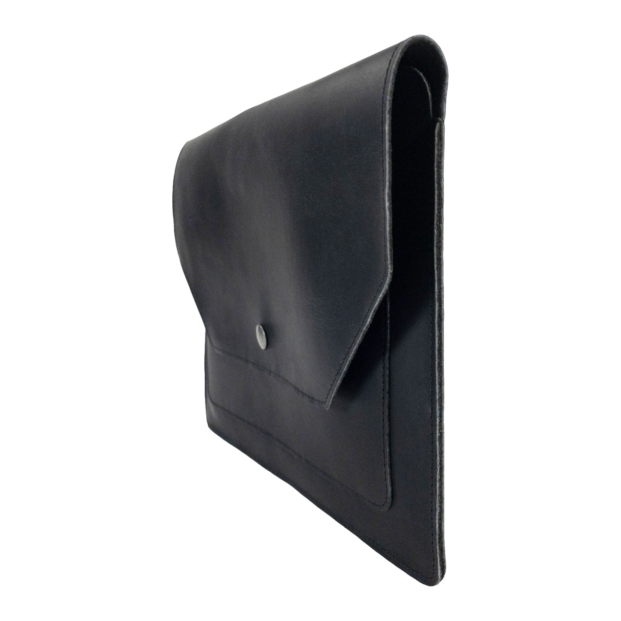 Side view of Hide & Drink's Slim Portfolio in black, highlighting its sleek profile as a handmade Flat Messenger Case. This Full Grain Leather Narrow Document Holder is perfect for any office accessory, made by artisans in La Antigua Guatemala & Oaxaca Mexico.