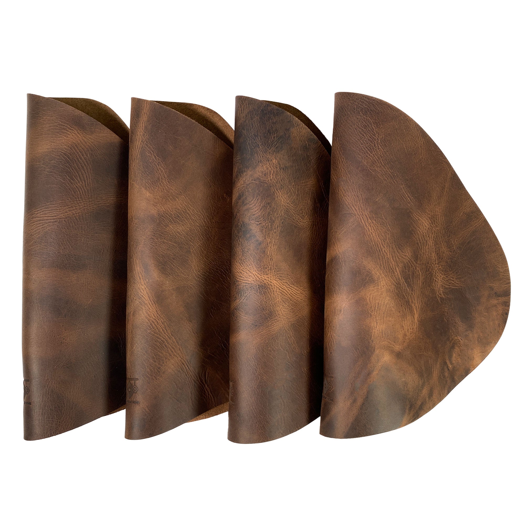 Elegant Leather Place Mats with Coasters Set of 4 from Leather At Home displayed in a folded arrangement. These rustic placemats are handmade from full grain leather, reflecting quality craftsmanship suitable for any dining setting. An essential addition to your kitchen table, made in La Antigua Guatemala & Oaxaca Mexico.