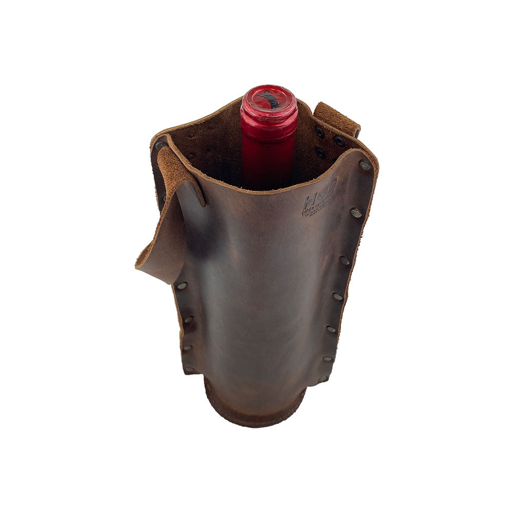 Top view of the Rustic Wine Carrier For Standard 750ml Bordeaux Bottle by Hide & Drink, emphasizing the quality of this Single Wine Carrier made with Full Grain Leather. Featuring artisan craftsmanship from small batch production, hand cut and sewn, fire branded, handmade in La Antigua Guatemala & Oaxaca Mexico.