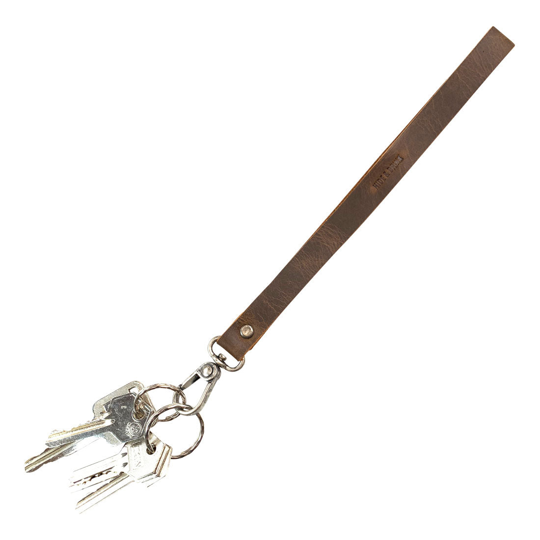 The Simple Thin Lanyard featuring keys attached, crafted from Full Grain Leather by Hide & Drink, designed for convenience and style. This Simple Thin Lanyard embodies the principles of Small Batch Production, Hand Cut, Hand Sewn, Fire Branded, Artisan, Handmade in La Antigua Guatemala & Oaxaca Mexico.