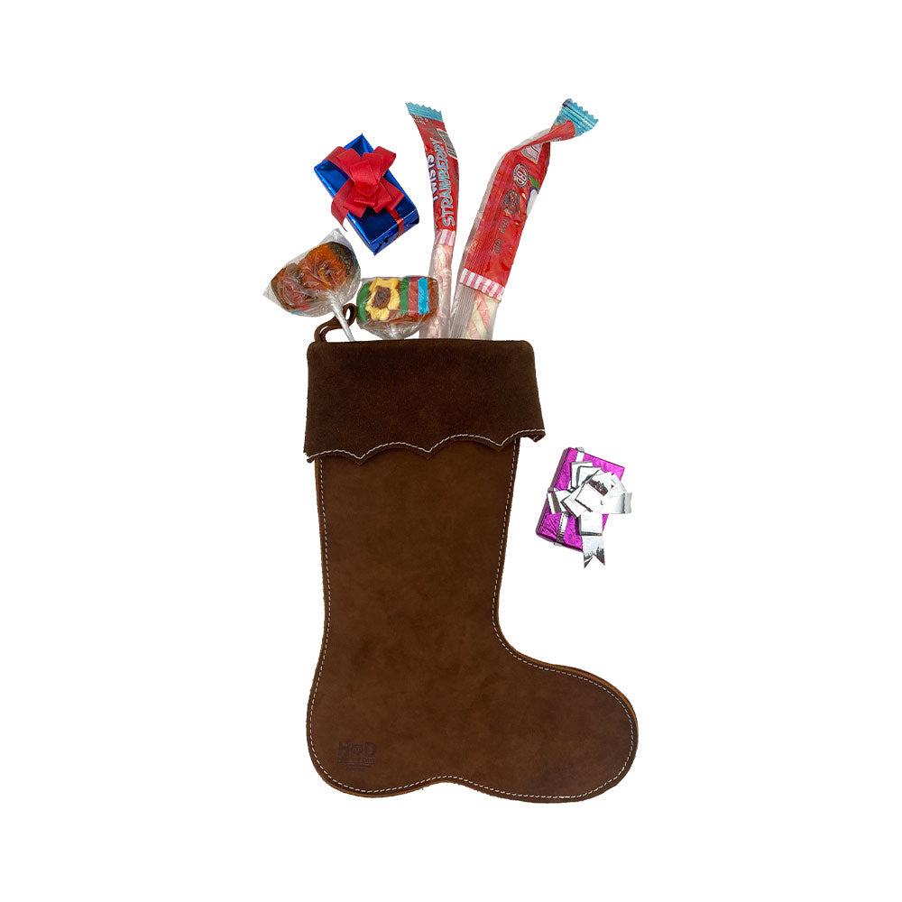The Hide & Drink Christmas Stocking Boot filled with assorted treats, featuring exquisite craftsmanship from soft suede. Perfect as Traditional Santa Stocking Decorations, this stocking is crafted from Full Grain Leather and embodies holiday cheer.