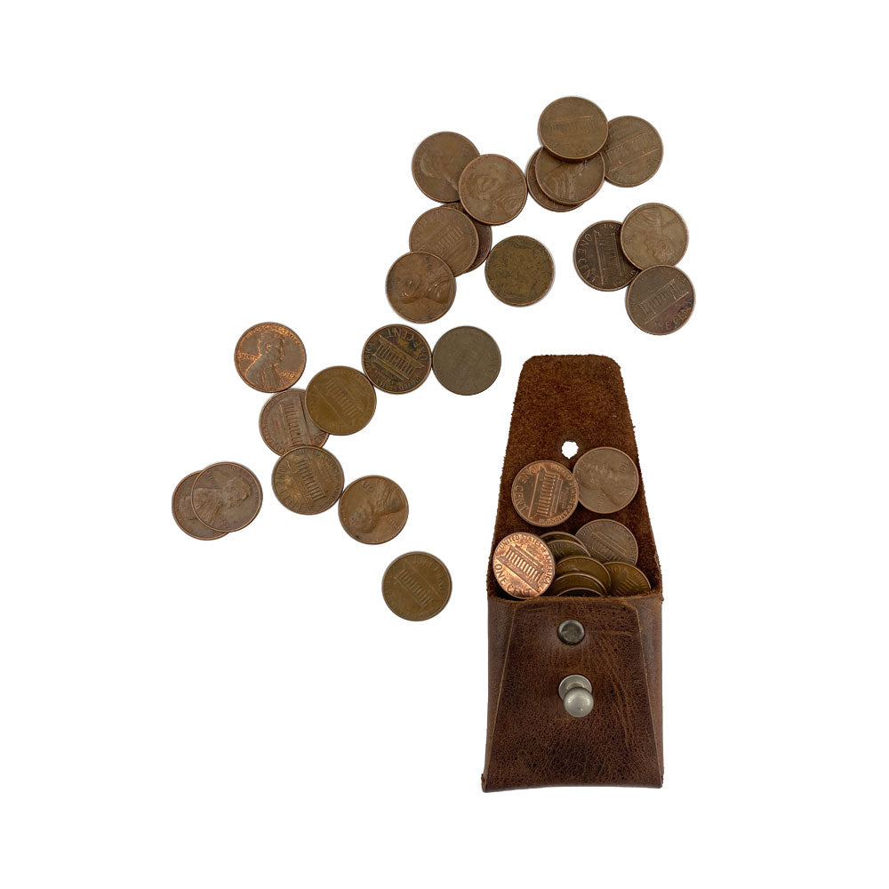 The Minimalist Square Coin Pouch by Hide & Drink filled with coins, showcasing its capacity and design. This fashionable yet practical leather pouch is hand-crafted from full grain leather to last a lifetime. Minimalist Coin Pouch, SD Card Holder, Wallet and Cash Organizer, Full Grain Leather, StockyardX, Small Batch Production, Hand Cut, Hand Sewn, Fire Branded, Artisan, Handmade in La Antigua Guatemala & Oaxaca Mexico.