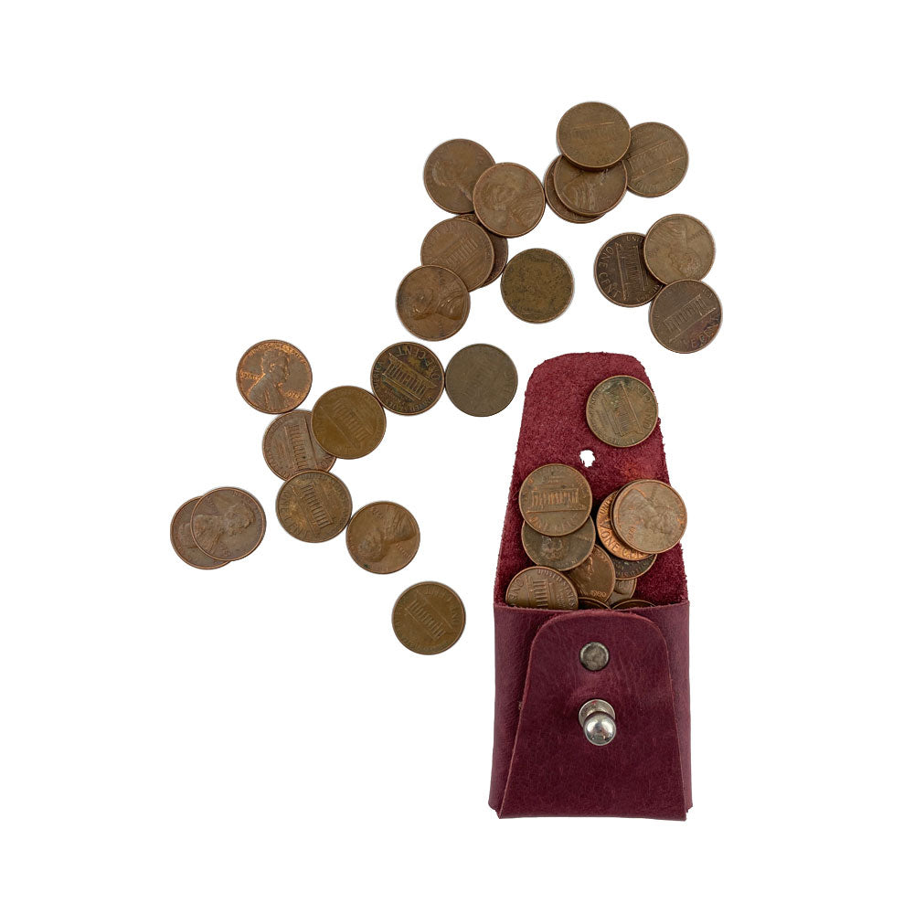 The burgundy Minimalist Square Coin Pouch by Hide & Drink filled with coins, showcasing its functionality and stylish design. This artisan-crafted full grain leather pouch is a perfect blend of elegance and practicality for everyday organization. Minimalist Coin Pouch, SD Card Holder, Wallet and Cash Organizer, Full Grain Leather, StockyardX, Small Batch Production, Hand Cut, Hand Sewn, Fire Branded, Artisan, Handmade in La Antigua Guatemala & Oaxaca Mexico.