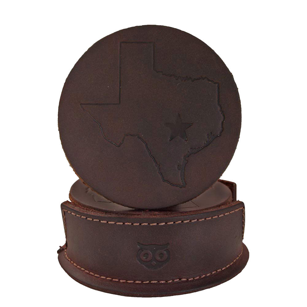 Durable Thick Leather Texas State Coasters (6-Pack) from Hide & Drink, featuring a stylish design with a Texas map and star, perfect for protecting surfaces. These coasters are part of a collection that showcases Small Batch Production, Hand Cut, Hand Sewn craftsmanship, and Fire Branded detailing, made in La Antigua Guatemala & Oaxaca Mexico.