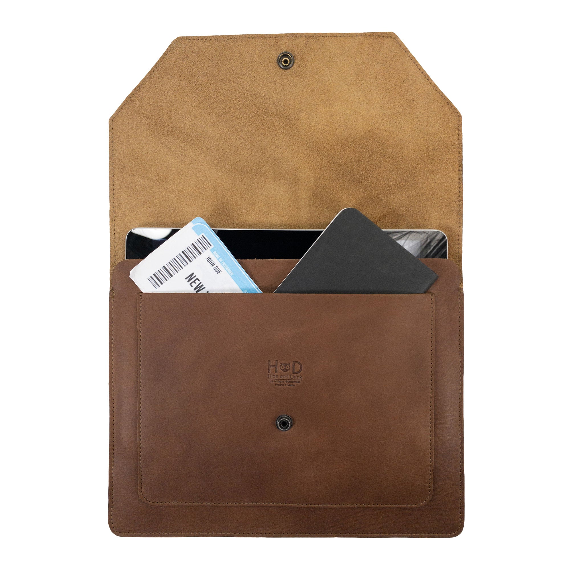 Hide & Drink's Slim Portfolio in brown with items displayed, illustrating its versatility as a handmade Flat Messenger Case. This Full Grain Leather Narrow Document Holder is a stylish office accessory made in La Antigua Guatemala & Oaxaca Mexico.