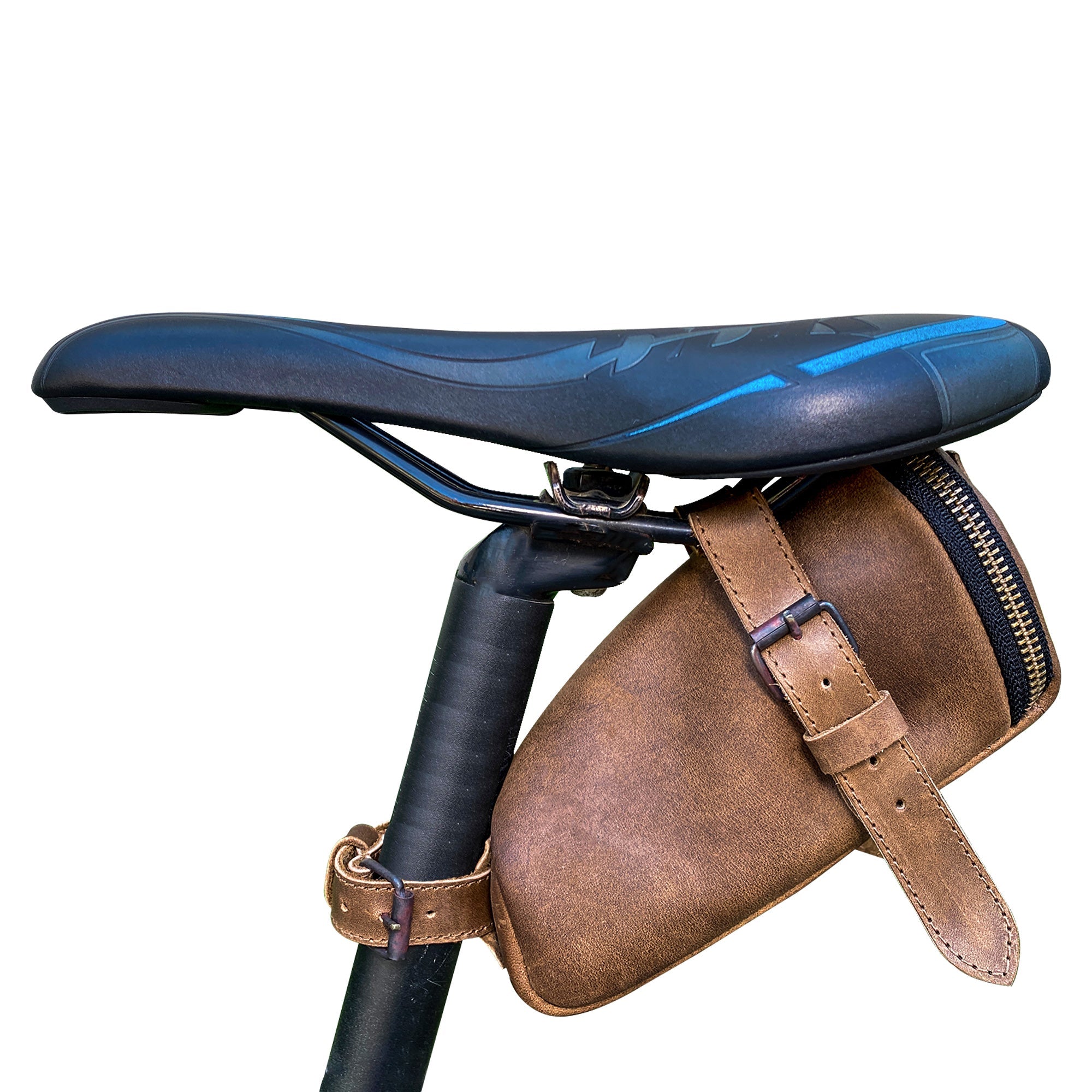 Hide & Ride Under Seat Pouch mounted on a bicycle saddle, showcasing its stylish design and full grain leather finish. Ideal as a Bicycle Under Seat Pouch, this multi-functional organizer for commuters is perfect for storing biker essentials. StockyardX supports small batch production with products that are hand cut, hand sewn, fire branded, and artisan-made in La Antigua Guatemala & Oaxaca Mexico.