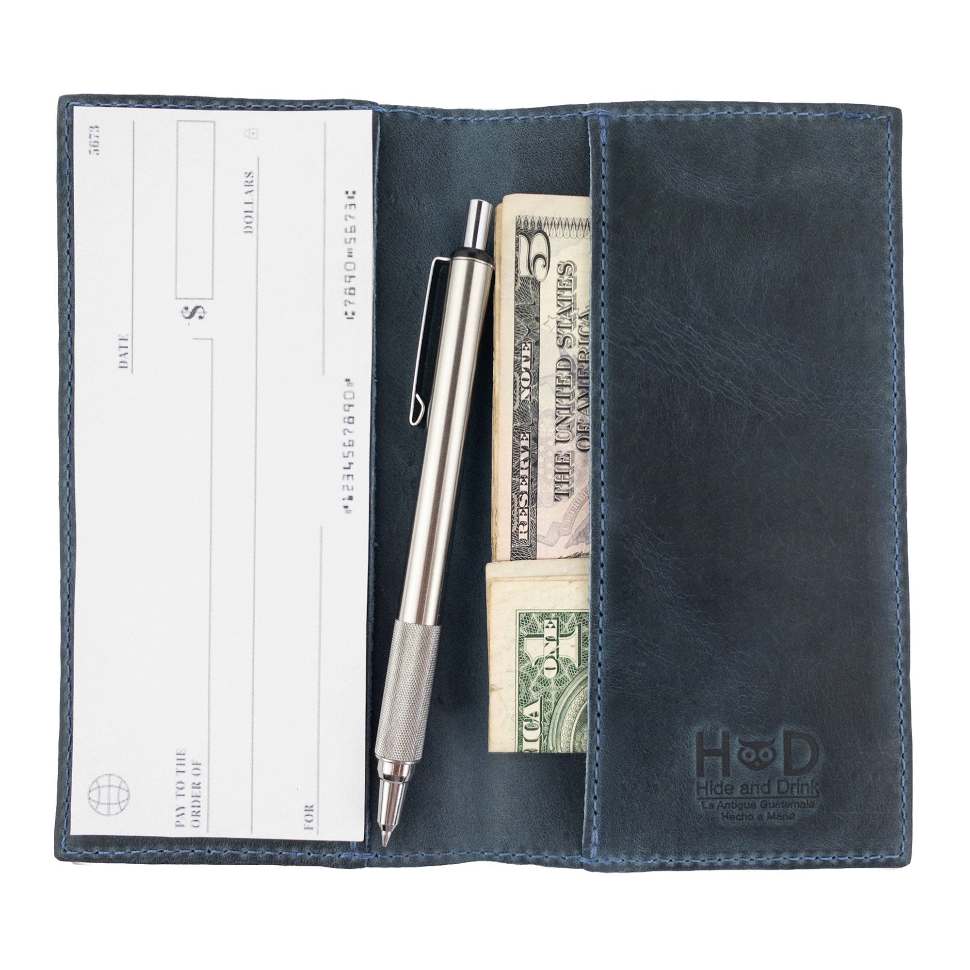 Clean layout of the brown Checkbook Leather Cover by Hide & Drink, positioned as a minimalist organizer for standard checkbooks. This artisan piece, handcrafted from full grain leather, comes from small batch production practices in La Antigua Guatemala and Oaxaca Mexico.