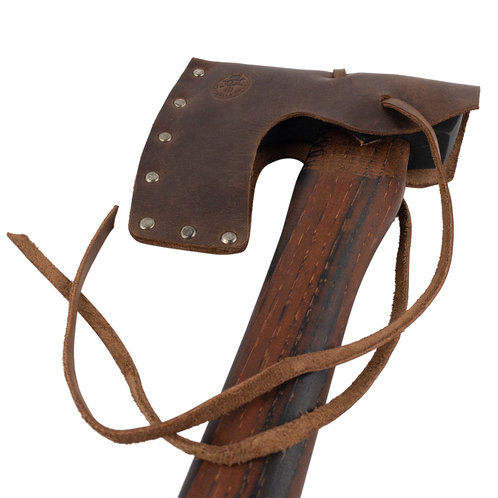 Detail of the Valhalla Gear Bearded Axe Head Sheath with String, focusing on its design and fit on a wooden axe handle. An example of a Riveted Axe Head Sheath with String that serves as a Blade Safety Sleeve, this Full Grain Leather item is crafted in La Antigua Guatemala & Oaxaca Mexico, emphasizing StockyardX's dedication to Handmade, artisan quality.
