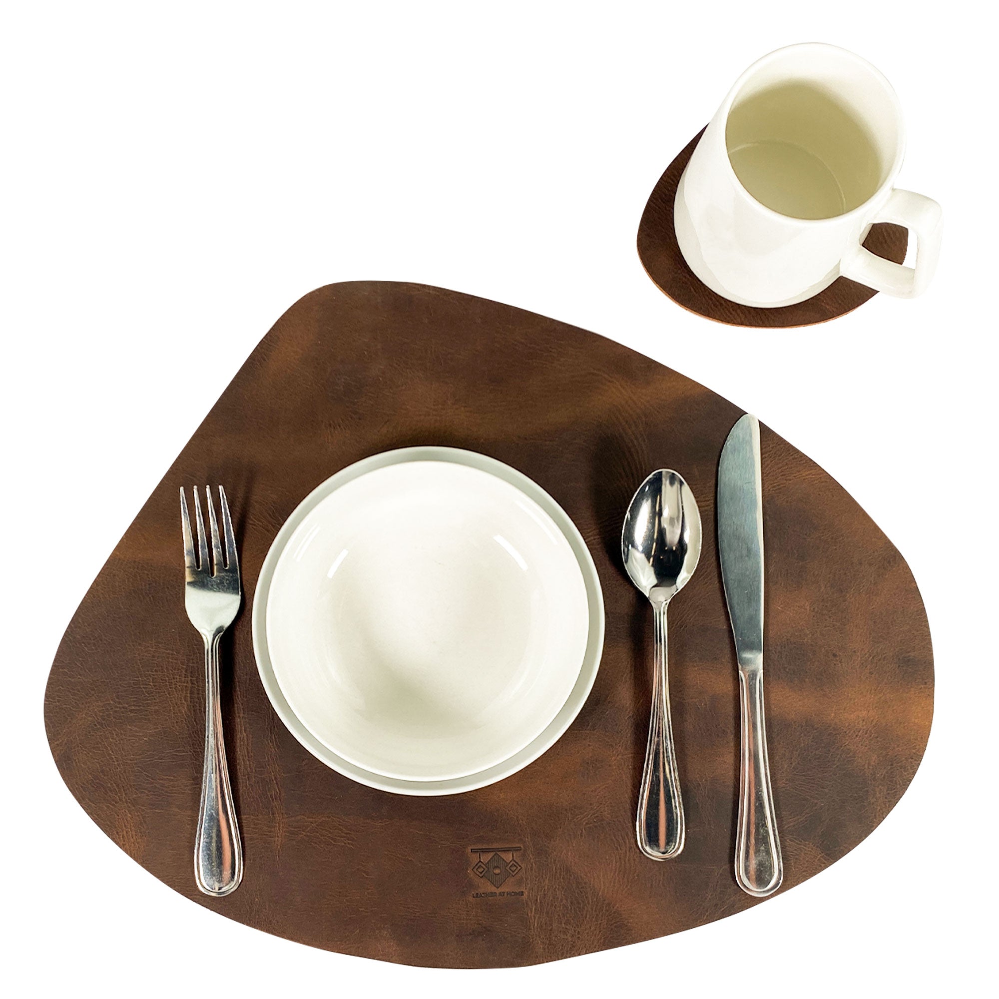Leather Place Mats with Coasters Set of 4 by Leather At Home, artistically arranged on a dining surface featuring utensils. These full grain leather placemats are beautifully rustic, perfect for home essentials that blend style and functionality, made in La Antigua Guatemala & Oaxaca Mexico.