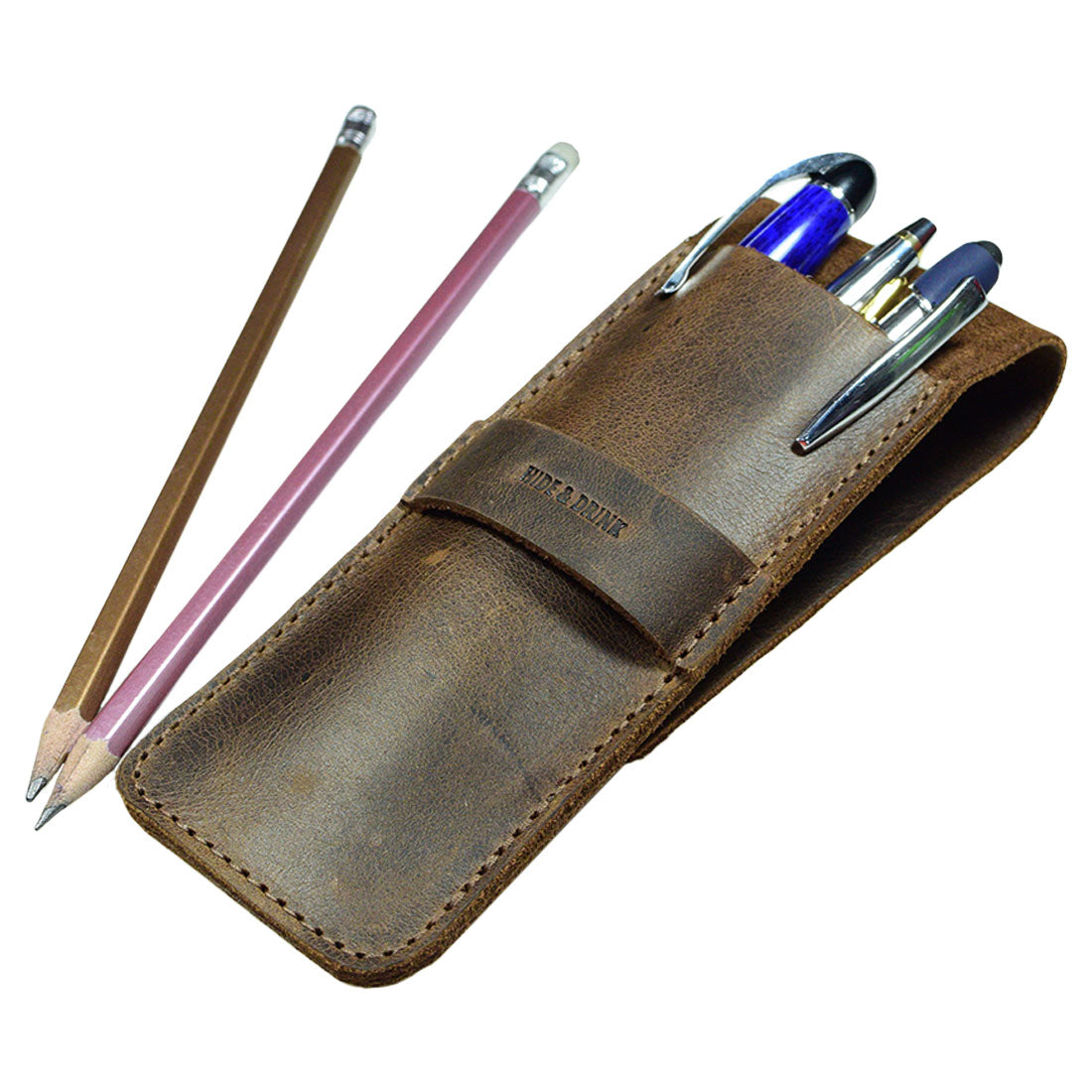 A stylish Pen Case by Hide & Drink, showcasing a leather exterior with multiple pens and pencils nestled within. This Pen Case Holder is an ideal Multi Pen Pouch designed to keep your office essentials organized. Made from durable Full Grain Leather, it reflects StockyardX's commitment to small batch production. The hand cut and hand sewn construction ensures quality, complemented by the fire branded logo, signifying artisan craftsmanship that is handmade in La Antigua Guatemala & Oaxaca Mexico.