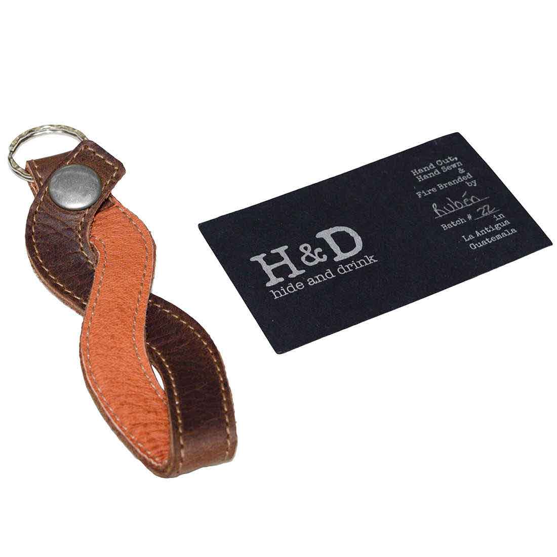 Braided Keychain by Hide & Drink displayed with branding card, reflecting the exquisite full grain leather craftsmanship and small batch production in La Antigua Guatemala and Oaxaca Mexico.