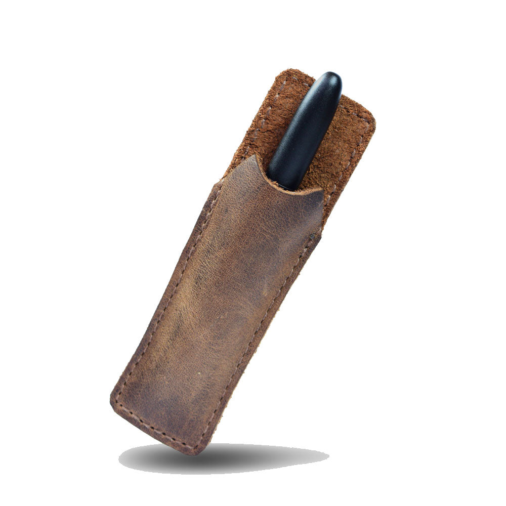 Hide & Drink Fisher Space Pen Case made from rustic full grain leather, perfect for holding individual pens. This stylish office pouch is designed for 3.75 in. adjustable pens, combining functionality with artisan craftsmanship. Ideal work and office essentials featuring small batch production, hand cut and sewn with fire branding from artisans in La Antigua Guatemala and Oaxaca Mexico.