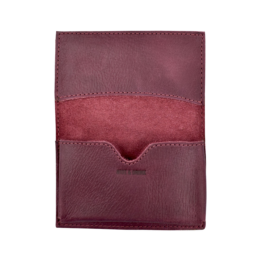 Inside view of Hide & Drink's Vintage Card Holder in burgundy leather, showing busy cards and cash thoughtfully stored. This handcrafted wallet is made from full grain leather as part of a small batch production process surrounding artistry in La Antigua Guatemala & Oaxaca Mexico.