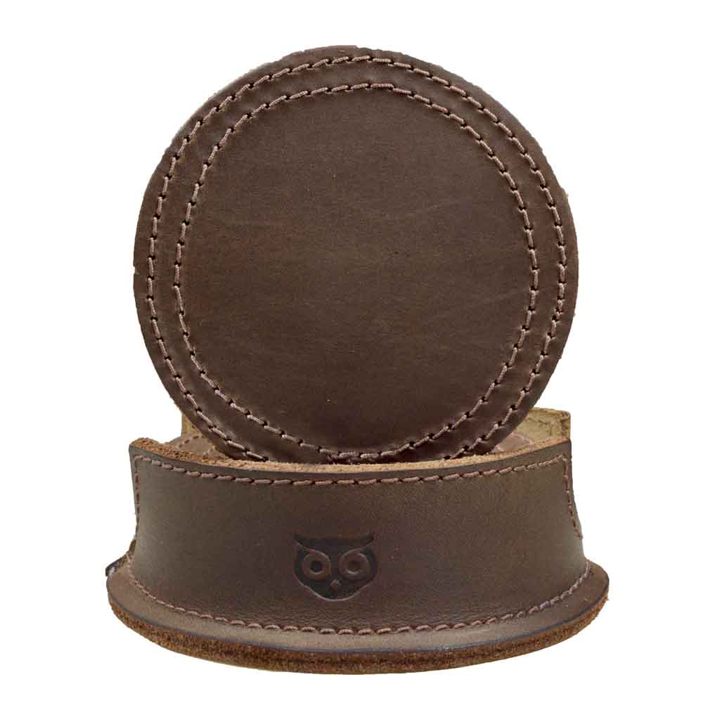 Thick Leather Coasters (6-Pack) by Hide & Drink featuring a circular coaster design in rich bourbon brown, made from full grain leather. This artisan piece demonstrates small batch production, hand cut and hand sewn, fire branded for quality, handcrafted in La Antigua Guatemala.