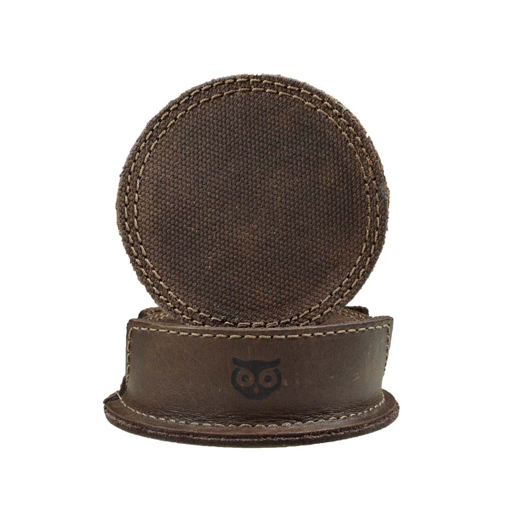 Showcasing a Circles Coaster (8-Pack) by Hide & Drink, featuring a beautifully handcrafted deep tray holder made from durable waxed canvas and full grain leather, ideal for protecting your table from coffee stains. This set of 8 durable coasters is perfect for home, office, bar, or kitchen.