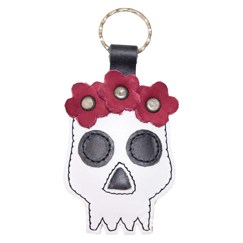 A beautifully handcrafted Mexican Skull Keychain by Hide & Drink, featuring intricate floral accents, perfect for Day Of The Dead celebrations. This unique piece showcases artisan craftsmanship with Full Grain Leather, making it a stylish accessory. Ideal for those who appreciate small batch production and handmade goods from La Antigua Guatemala & Oaxaca Mexico.
