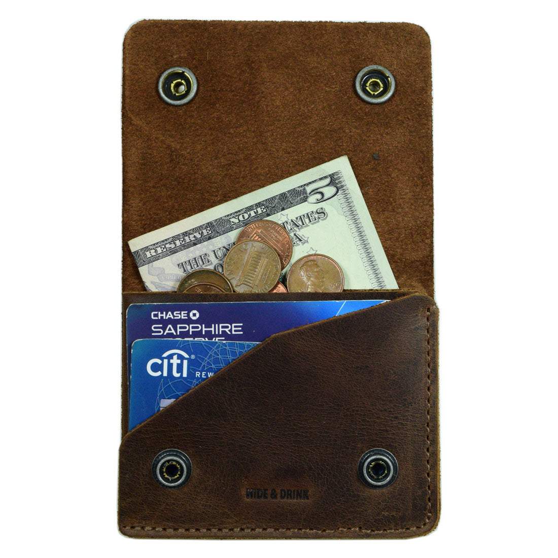 A close-up view of the Hide & Drink Sandwich Card Holder featuring a minimalist design. This Double Snap Card Holder holds up to 4 cards, along with cash and coins. Made from Full Grain Leather, it's a stylish cash organizer and coin case. Perfectly suited for those seeking quality accessories, each is handmade in La Antigua Guatemala & Oaxaca Mexico.