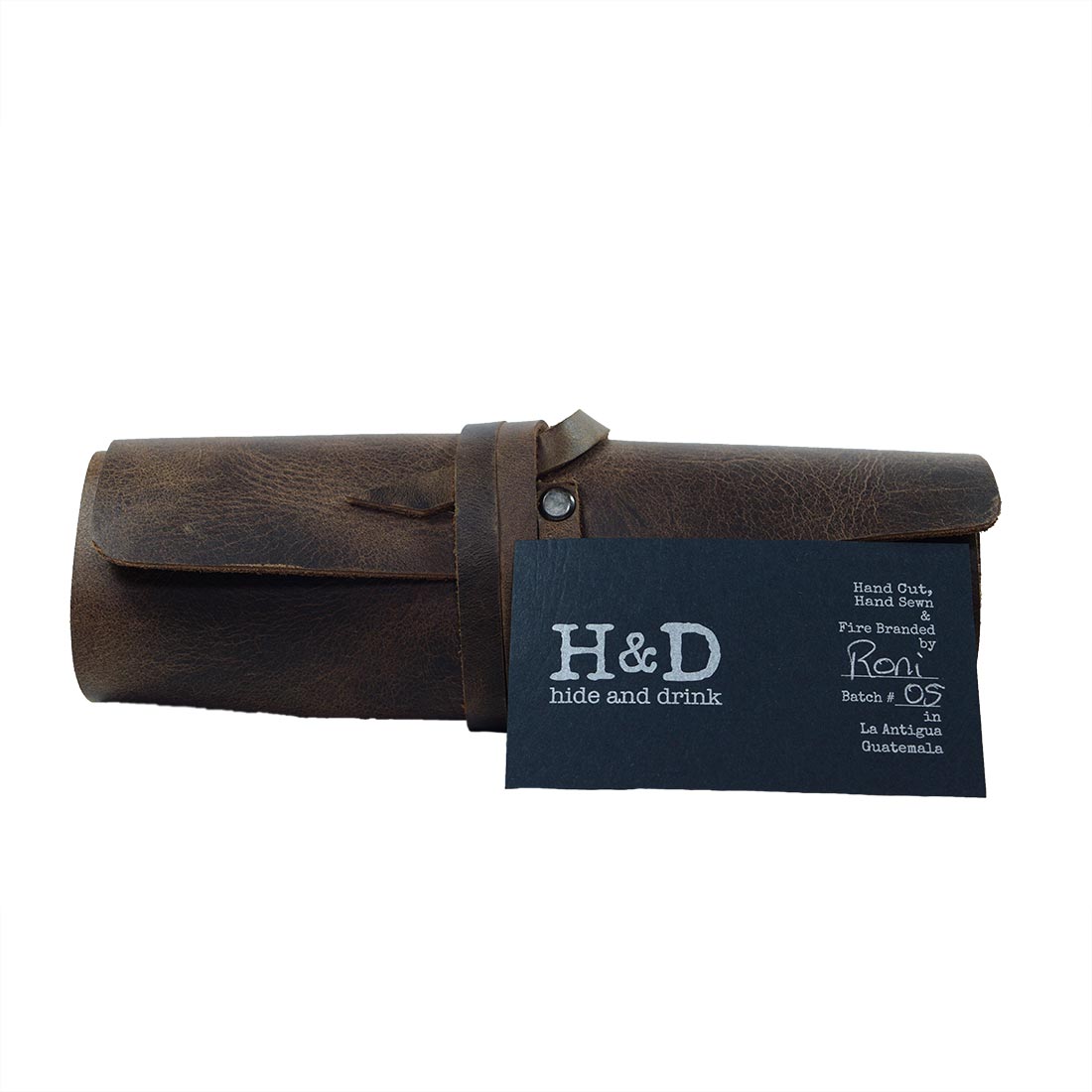 Hide & Drink Cord Pouch with tag, emphasizing its authenticity and handmade quality as a cord wrap. This full grain leather travel bag is crafted by skilled artisans in small batch production in La Antigua Guatemala & Oaxaca Mexico.