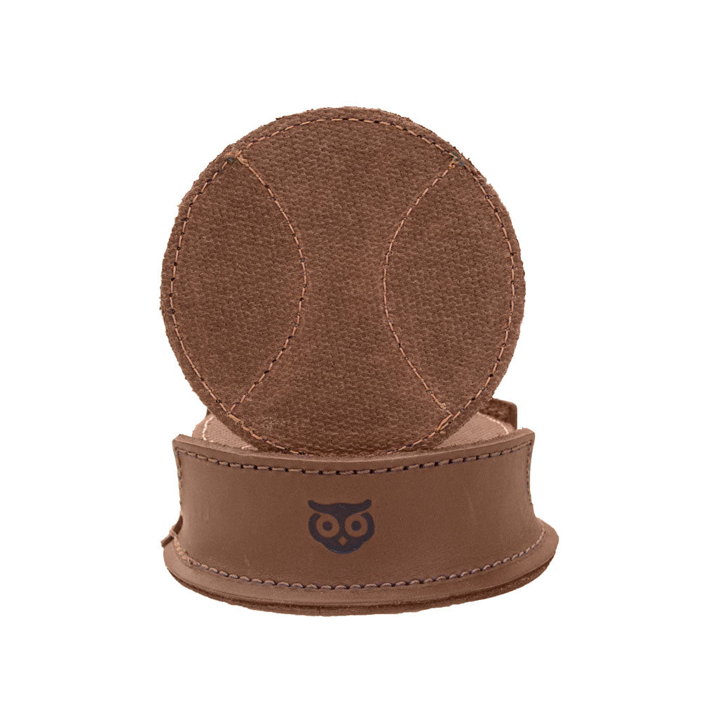 A handcrafted coaster holder with a baseball design, part of the Hide & Drink All Baseball Coaster (8-Pack). Made of Waxed Canvas & Full Grain Leather, these coasters provide stain protection for glasses and cups at home, kitchen, or bar, featuring artisan craftsmanship from small batch production in La Antigua Guatemala & Oaxaca Mexico.