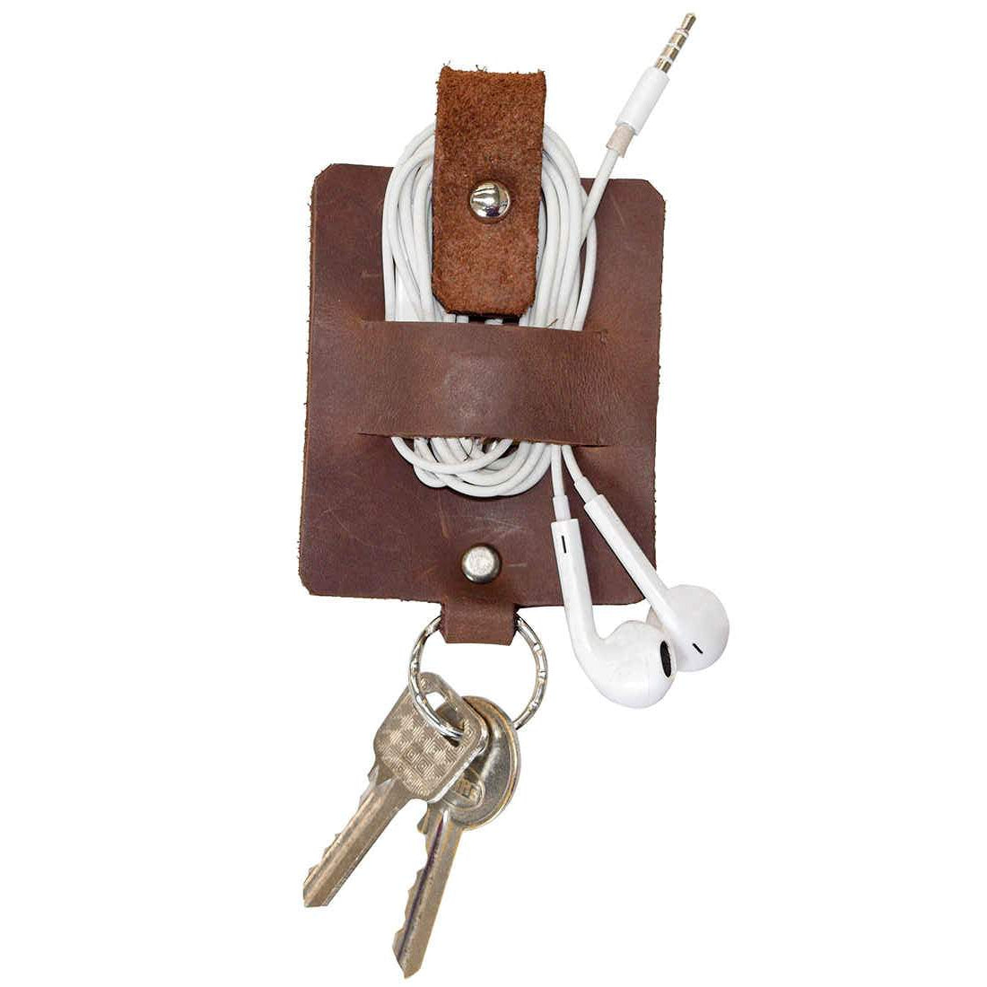 Hide & Drink Cable Holder with Key Ring featuring a stylish design for organizing cords and earphones, crafted from Thick Full Grain Leather. This artisan-made accessory acts as a keychain and cable holder, perfect for everyday use or travel. Ideal as a thoughtful gift, this handmade item supports small batch production in La Antigua Guatemala & Oaxaca Mexico.