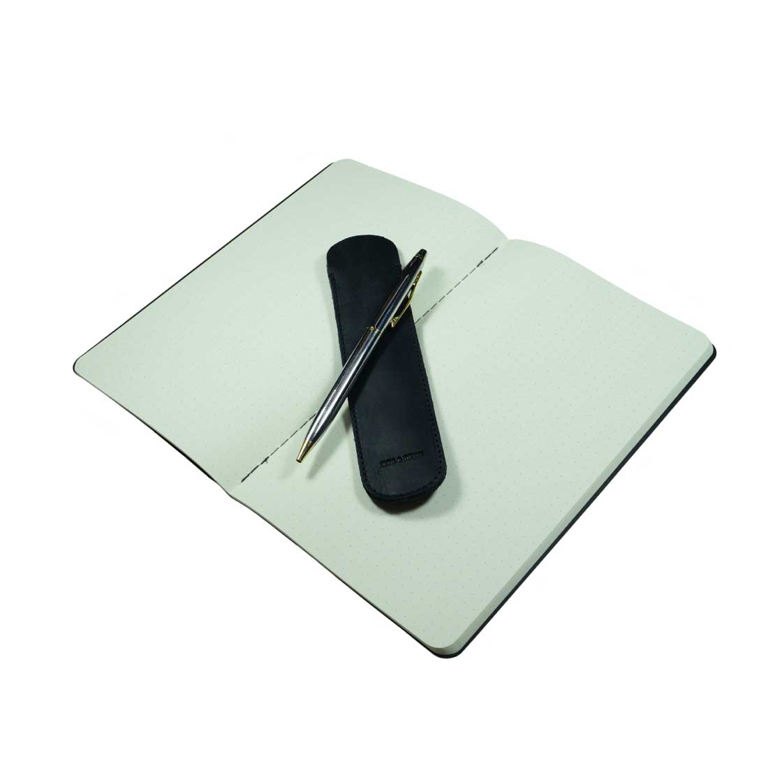 This image features the Vintage Pen Sleeve in an open notebook setting, designed by Hide & Drink, showcasing its perfect fit and sleek design made from Full Grain Leather. A unique piece with an artisan touch.