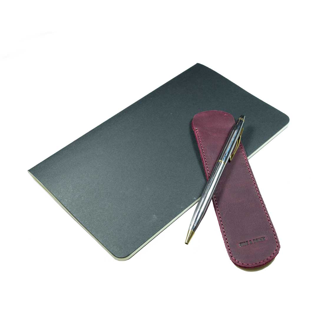 The Vintage Pen Sleeve by Hide & Drink elegantly rests with a pen, illustrating its functional and stylish design. Made in La Antigua Guatemala & Oaxaca Mexico, it’s a perfect addition to any writer’s toolkit.