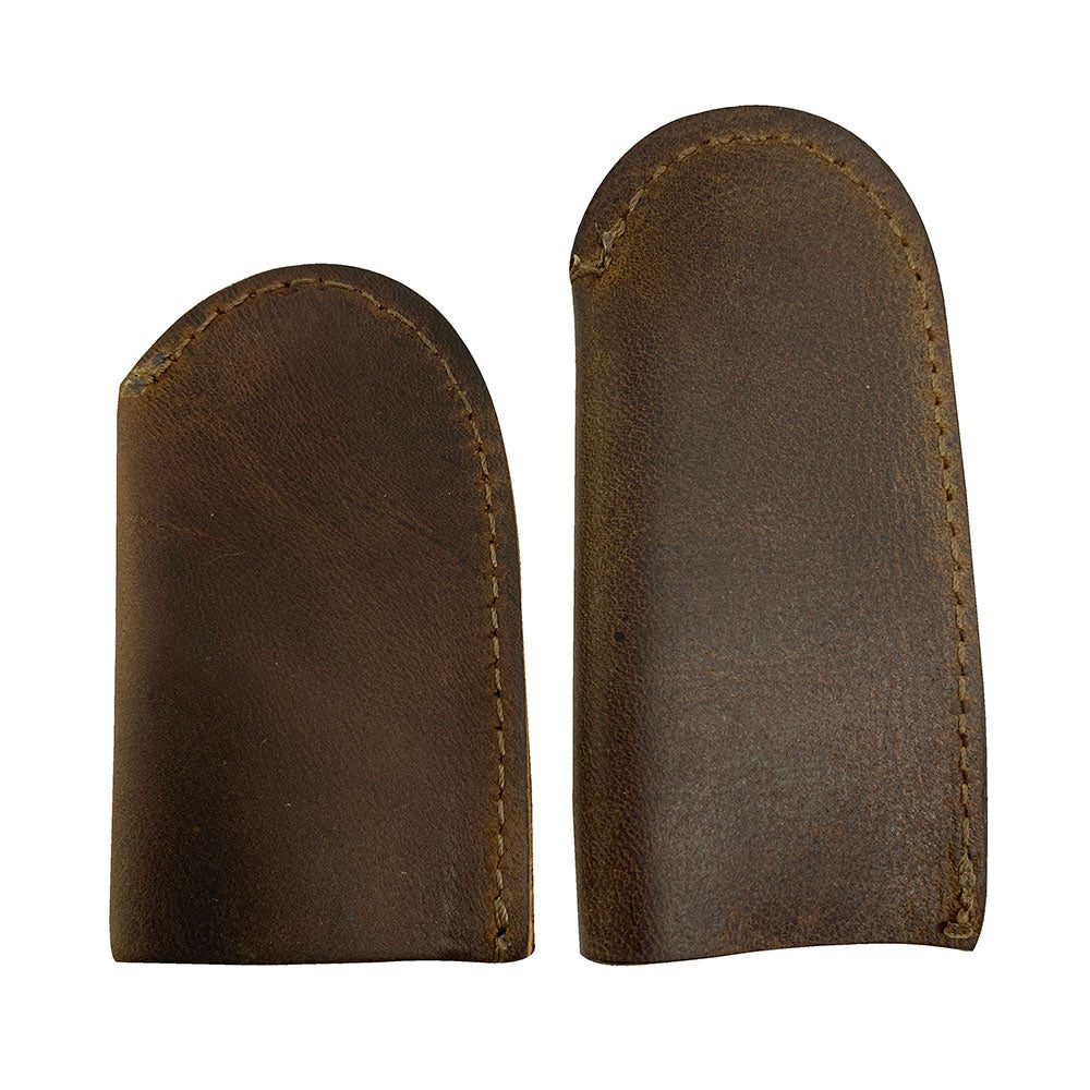 Leather Thimble for Thumb & Index Finger (3 Paires) by Hide & Drink highlighting a pair of thimbles from a set of 3 pairs (6 pieces) designed for finger protection. Perfect for sewing, hand appliqué, EPP, and quilting, these thimbles are made from durable full grain leather. StockyardX offers these artisan, handmade pieces, carefully hand cut and hand sewn in La Antigua Guatemala & Oaxaca Mexico, featuring a unique fire branded design.
