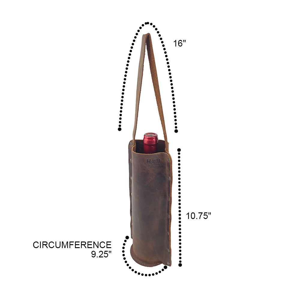 Dimensions of the Rustic Wine Carrier For Standard 750ml Bordeaux Bottle by Hide & Drink, illustrating the practical design of this Single Wine Carrier crafted from Full Grain Leather. Perfect for showcasing artisanal small batch production techniques, hand cutting, hand sewing, and fire branding, handmade in La Antigua Guatemala & Oaxaca Mexico.