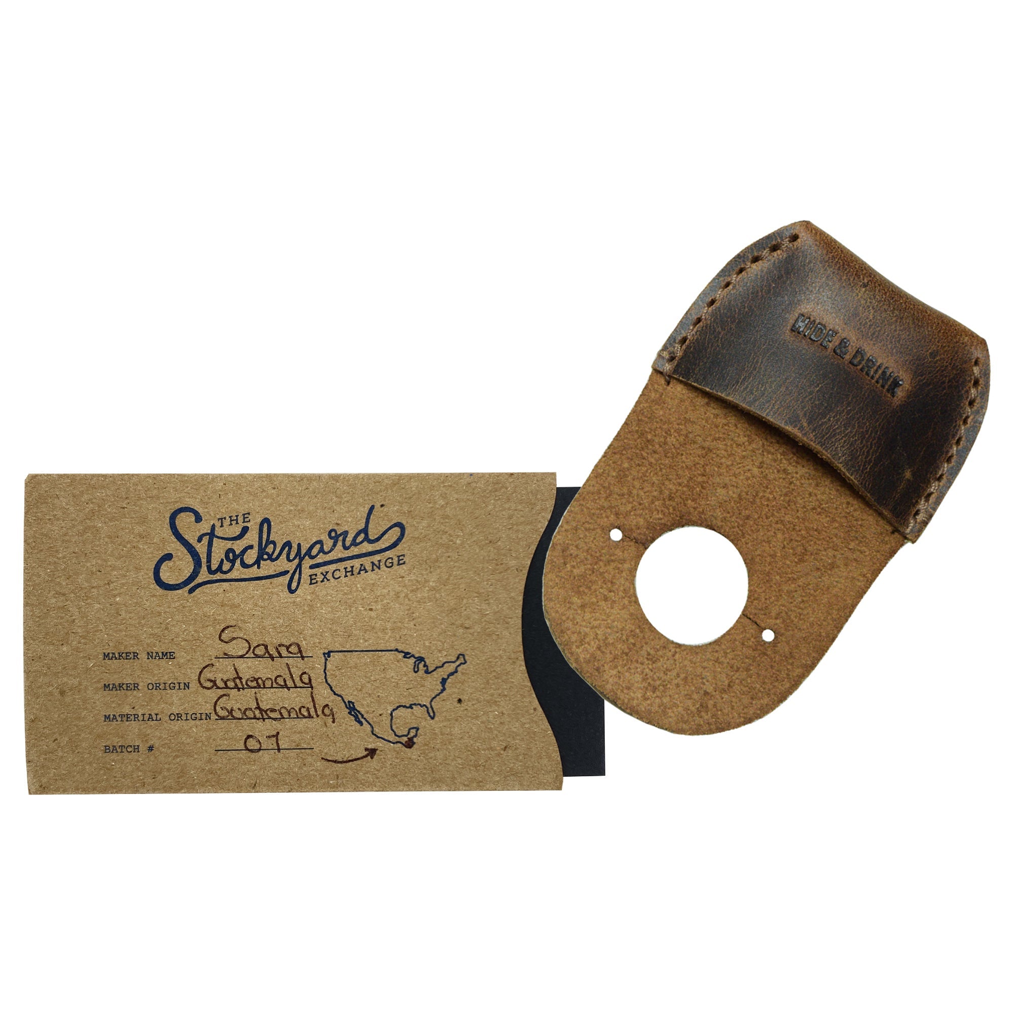 The Hide & Drink Thumb Guard alongside its packaging, highlighting the artisan nature and care put into each product. This Full Grain Leather Finger Protector is perfect for woodworking enthusiasts. Handmade in La Antigua Guatemala, this piece signifies small batch production and exceptional craftsmanship.