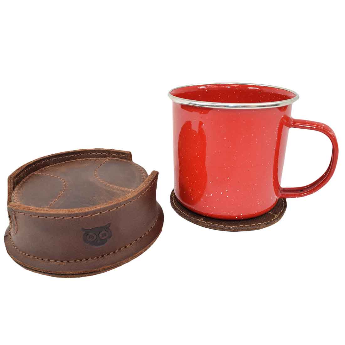 A vibrant enamel mug placed on the Hide & Drink All Baseball Coaster (8-Pack) beside its tray holder, illustrating the coasters' function in protecting surfaces from stains. These handcrafted coasters made from Waxed Canvas & Full Grain Leather are artisan products made in La Antigua Guatemala & Oaxaca Mexico.
