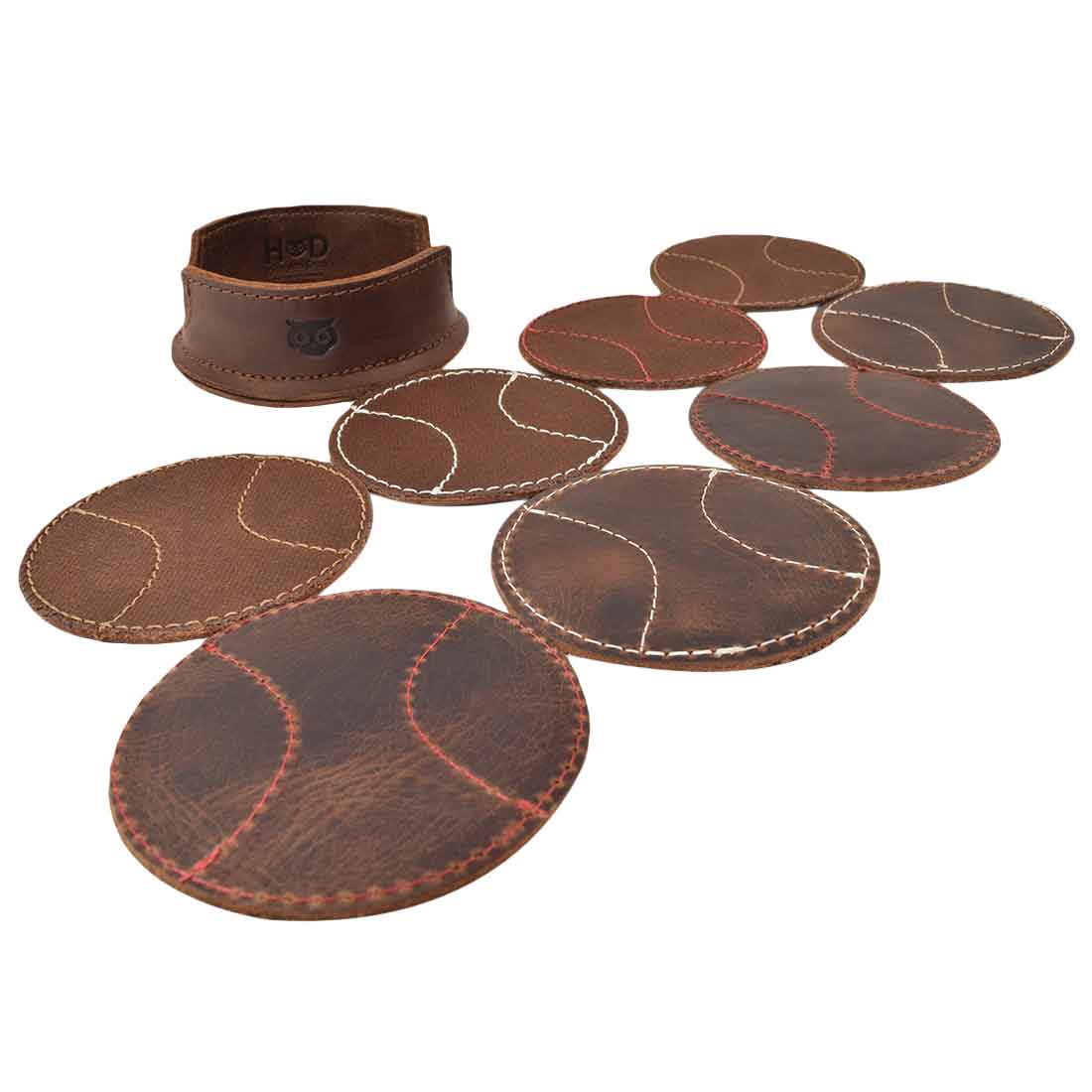 An artistic arrangement of the Hide & Drink All Baseball Coaster (8-Pack) showing the leather coasters and tray holder, showcasing high-quality Waxed Canvas & Full Grain Leather. These coasters are perfect for protecting tables at home, kitchen, or bar, handcrafted in La Antigua Guatemala & Oaxaca Mexico.