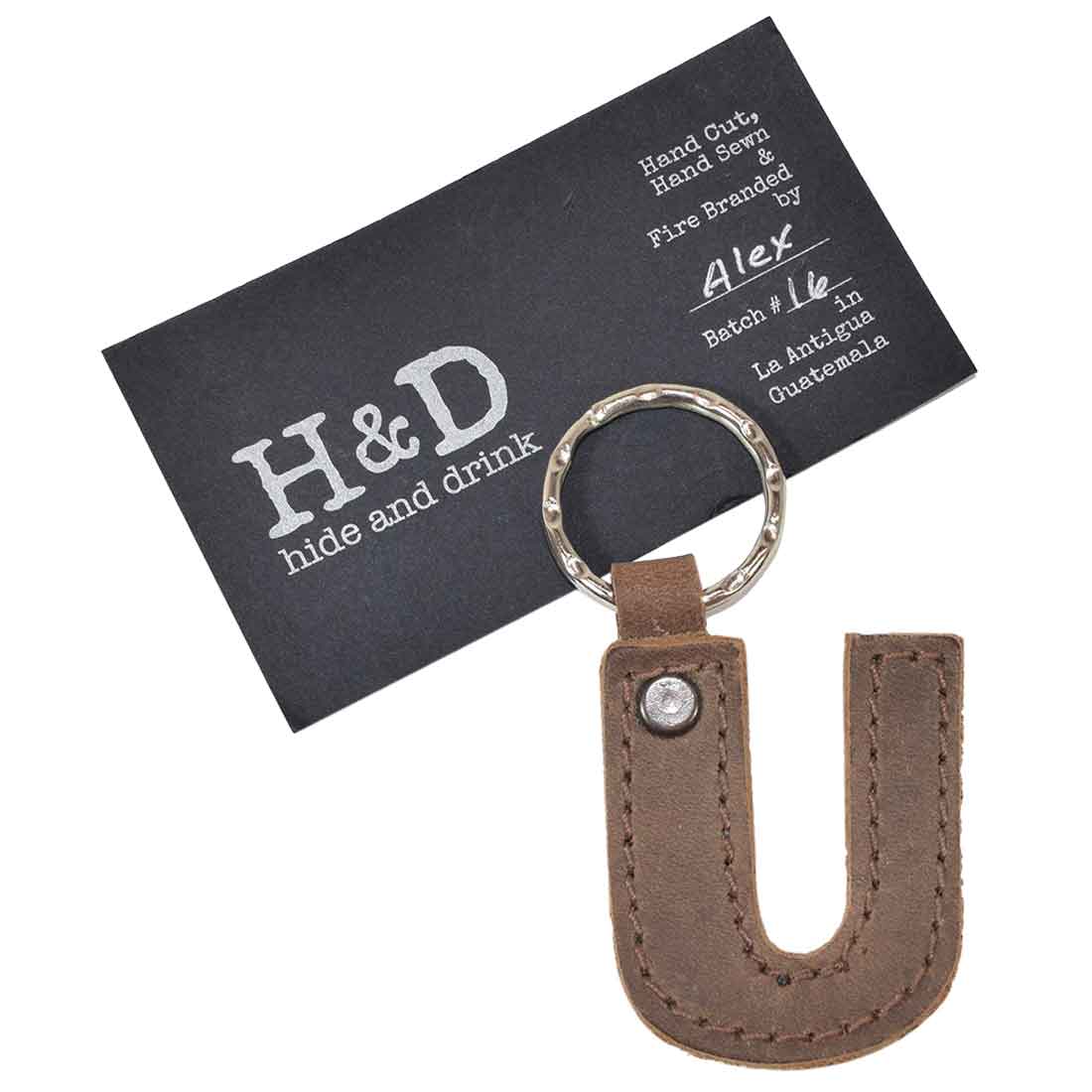 Close-up of letter U keychain by Hide & Drink. This Alphabet Letter Keychain made from thick Full Grain Leather captures the artisanship involved in small batch production from La Antigua Guatemala.