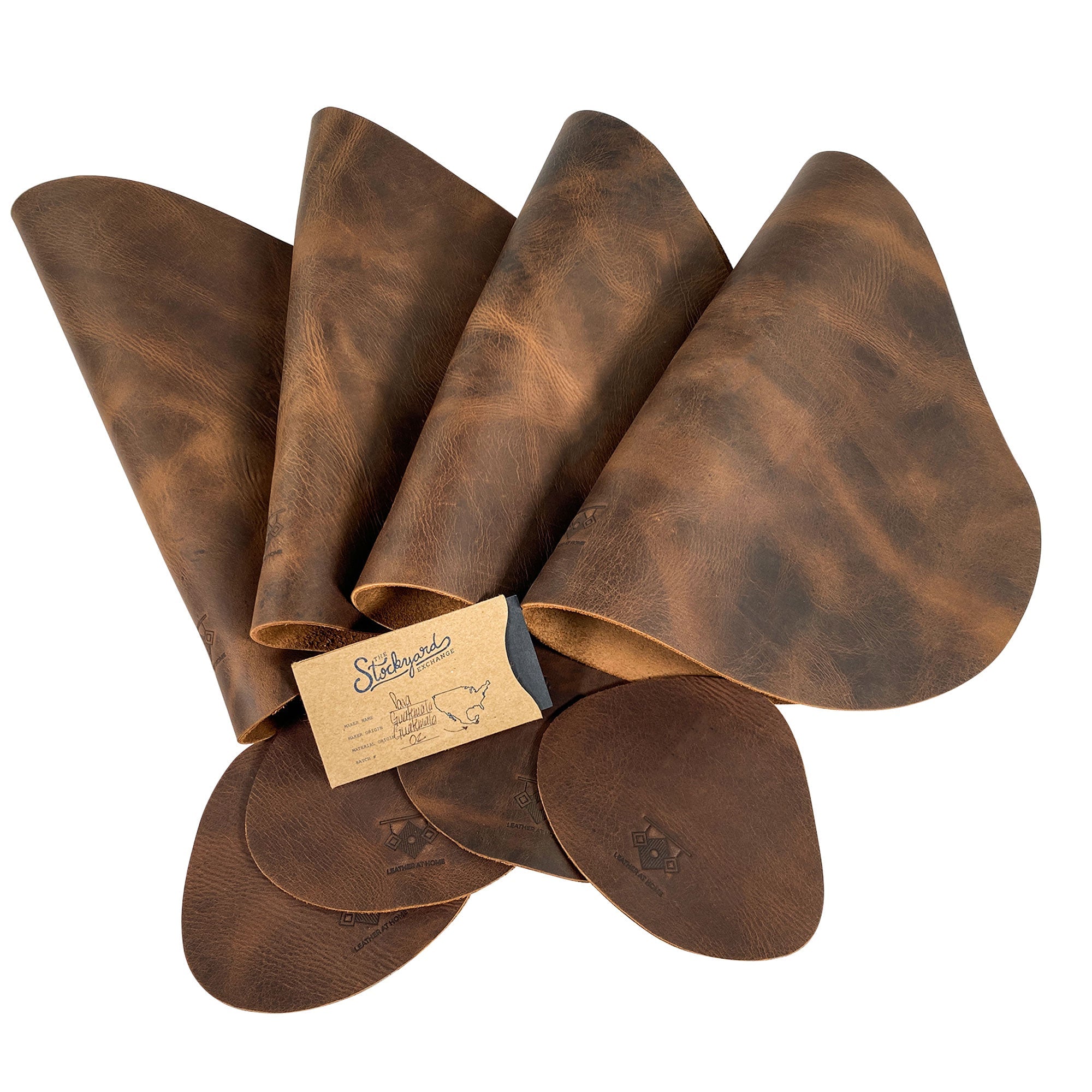 Leather Place Mats with Coasters Set of 4 by Leather At Home, neatly organized with branding tag. Showcasing the exquisite craftsmanship and rustic aesthetic of handmade full grain leather, these decorative kitchen table mats are essentials you’ll cherish, made in La Antigua Guatemala & Oaxaca Mexico.