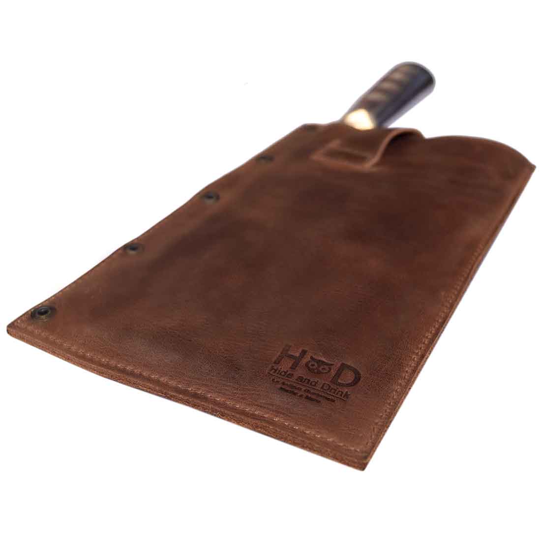 Hide & Drink Butcher Knife Holster presenting its durable construction and fine stitching, designed to securely fit claver butcher knives. This rustic sheath made of premium full grain leather is an ideal addition to kitchen essentials, showcasing the small batch production approach of artisans from La Antigua Guatemala & Oaxaca Mexico.