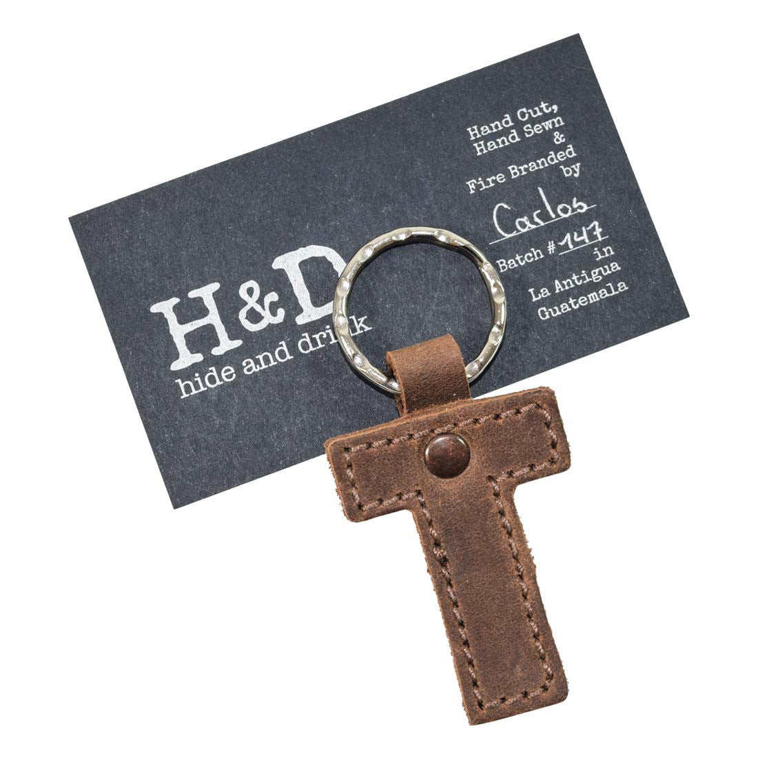 Close-up of letter T in a leather keychain by Hide & Drink. This Alphabet Letter Keychain is made from thick Full Grain Leather, showcasing the artisan methods of small batch production from La Antigua Guatemala.