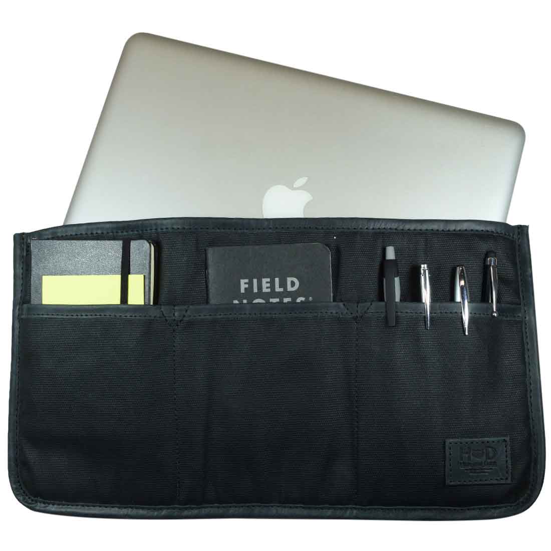 A chic, handmade Laptop Protector W/Organizer for Bag by Hide & Drink, showcasing compartments for pens and notebooks. This Waxed Canvas Laptop Protector W/Storage Pockets serves as a Briefcase Organizer, perfectly fitting in handbags. Small Batch Production, Hand Cut, Hand Sewn, Fire Branded by artisans in La Antigua Guatemala & Oaxaca Mexico.