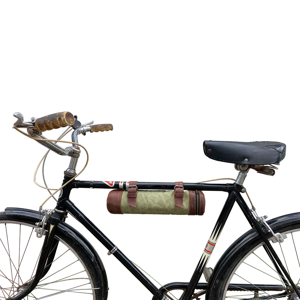 A stylish bicycle displaying the Bicycle Tube from Hide & Drink, perfect for securely holding drinks while biking. This Bike Pack Tube features full grain leather craftsmanship, making it a stylish accessory for any trip. Ideal for riders who appreciate small batch production and artisan quality. Handmade in La Antigua Guatemala and Oaxaca Mexico.
