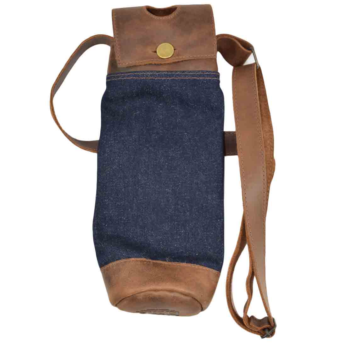 Elegant Hide & Drink Wine Caddy made from repurposed denim and full grain leather, designed for wine transportation. This handmade wine carrier tote highlights small batch production, hand cut craftsmanship, and fire branded detailing from artisans in La Antigua Guatemala and Oaxaca Mexico.